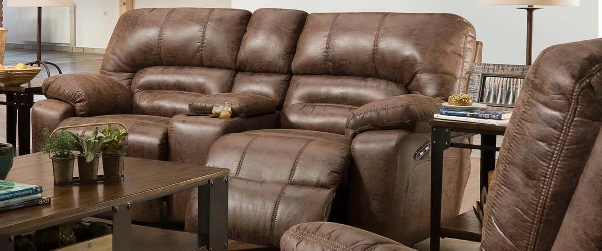 brown leather loveseat with coffee table