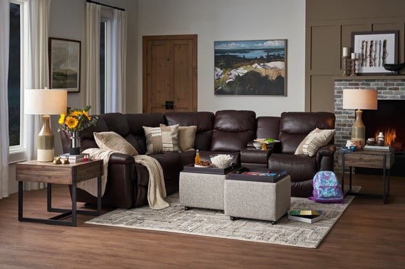 brown leather sectional sofa in living room with fireplace