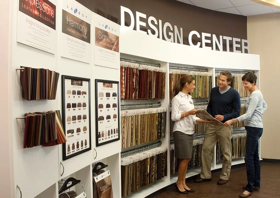 designer helping customers pick out fabric for furniture