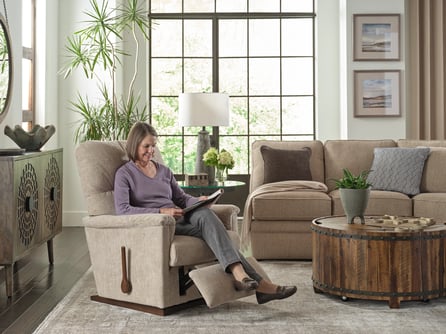 woman reading in recliner chair in living room