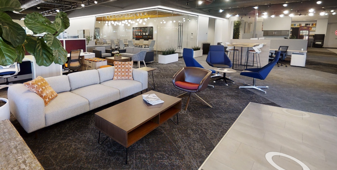 Modern Furniture store showroom with white leather couch and blue swivel accent chairs