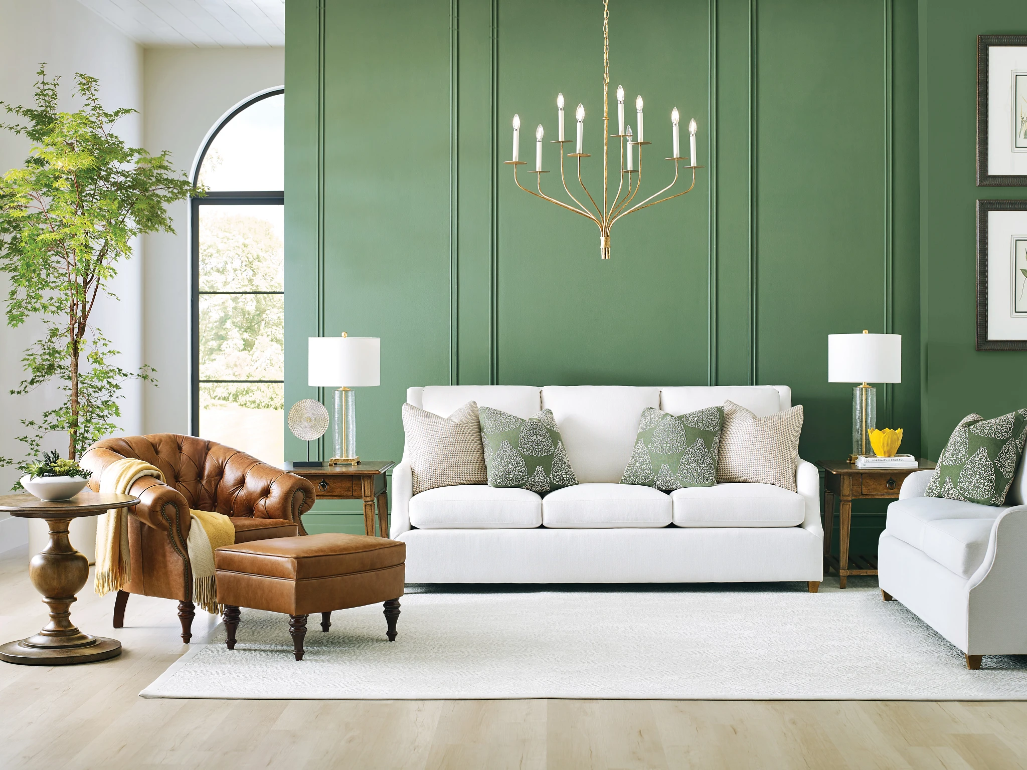 white sofa and brown leather accent chair in living room