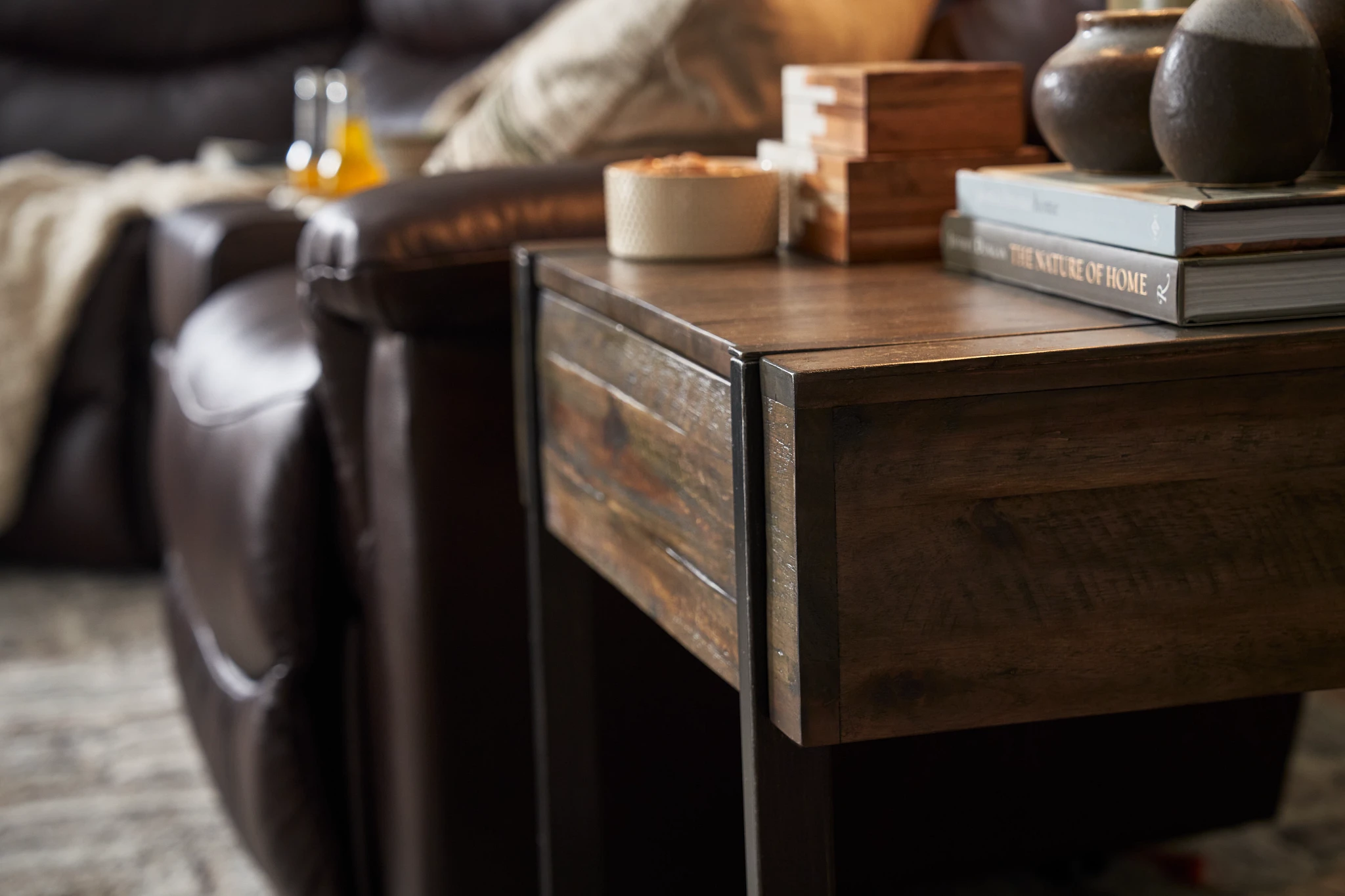 wooden end table next to recliner sofa